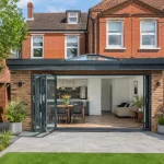 A beautiful, cost-effective small home extension with a flat roof and bi-fold doors on a UK property.