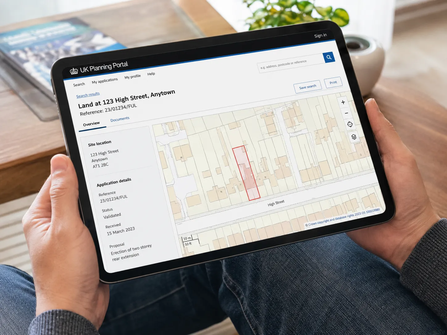 A homeowner checking the gov.uk planning portal on a tablet device.