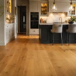 A beautiful modern kitchen showcasing the latest trends, kitchen flooring ideas featuring warm engineered oak planks.